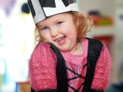 Girl playing dress up at Juniors Day Nursery.