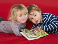 Two young children on the sofa at Juniors Day Nursery.