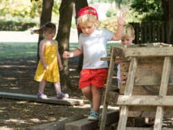 Pre-school children playing in the garden at Juniors Day Nursery.