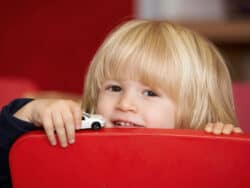 Pre-school child playing cars in the pre-school room at Juniors Day Nursery.