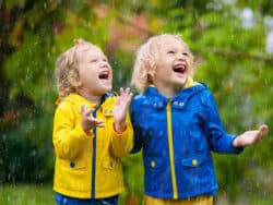 Children playing in the rain at Juniors Day Nursery.