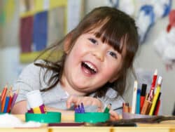 Girl drawing at Juniors Day Nursery.