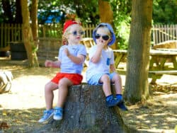 Two children in sunglasses at Juniors Day Nursery.