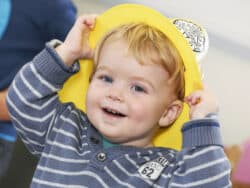 Boy dressing up at Juniors Day Nursery.