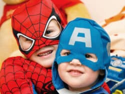 Two Pre-school children dressing up at Juniors Day Nursery.