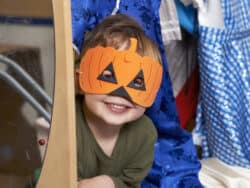 Young boy in mask, dressing up at Juniors Day Nursery.