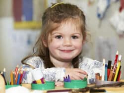 Girl drawing at Juniors Day Nursery.