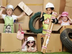 Four children role playing in the garden at Juniors Day Nursery.