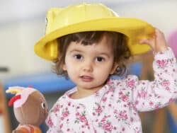 Toddler dressing up at Juniors Day Nursery.