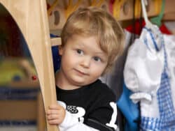 Toddler dressing up at Juniors Day Nursery.