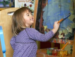 Young Girl painting at Juniors Day Nursery.