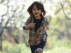 Young boy running outside Juniors Day Nursery.