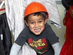 Young boy dressing up at Juniors Day Nursery.