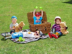 Pre-school children having a picnic outside at Juniors Day Nursery.